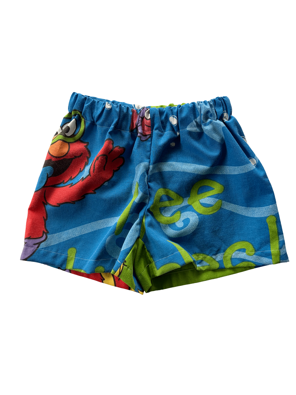 A pair of blue patterned shorts with a colorful cartoon print, featuring elmo. Made from a secondhand duvet.