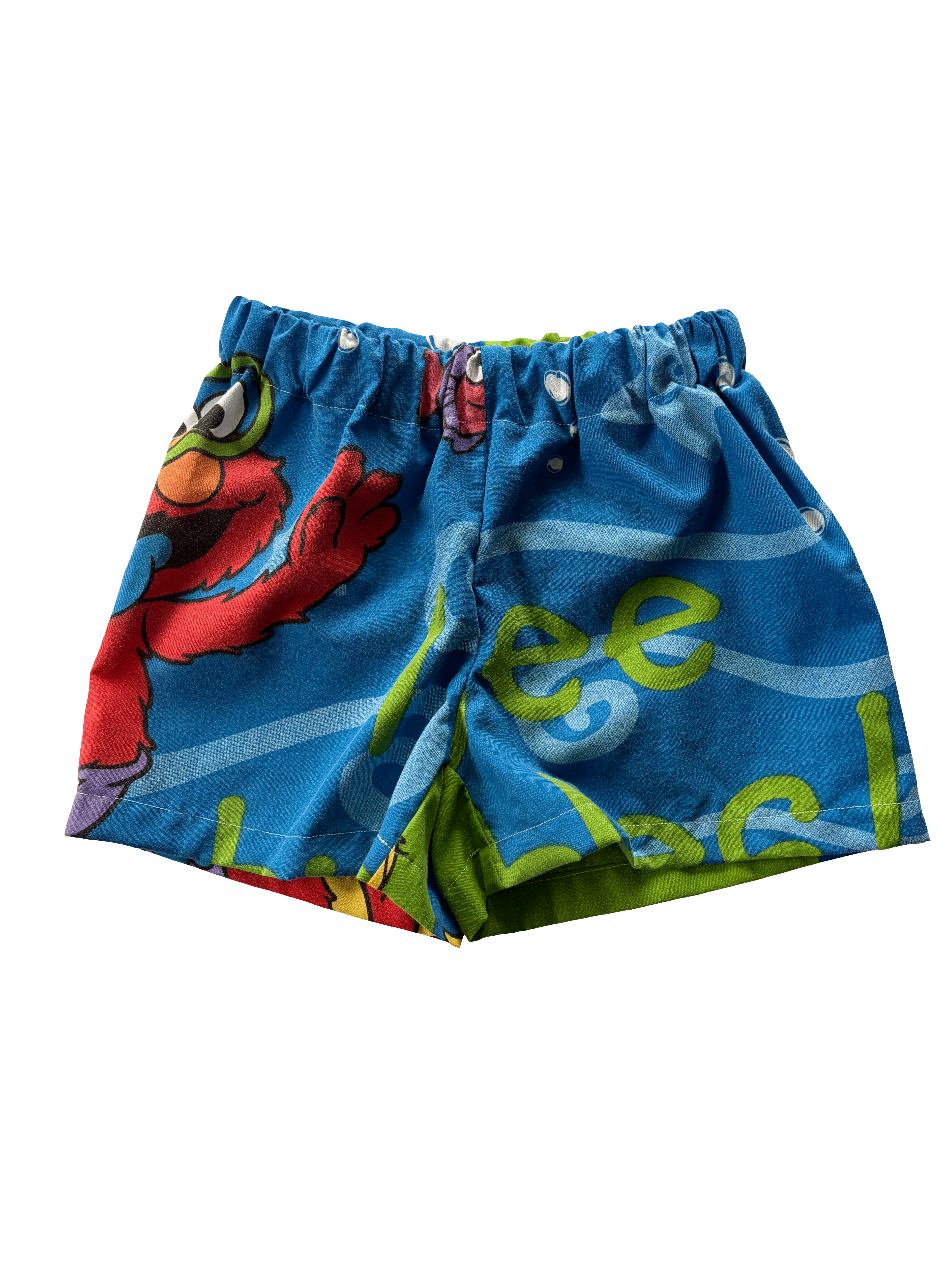 A pair of blue patterned shorts with a colorful cartoon print, featuring elmo. Made from a secondhand duvet.