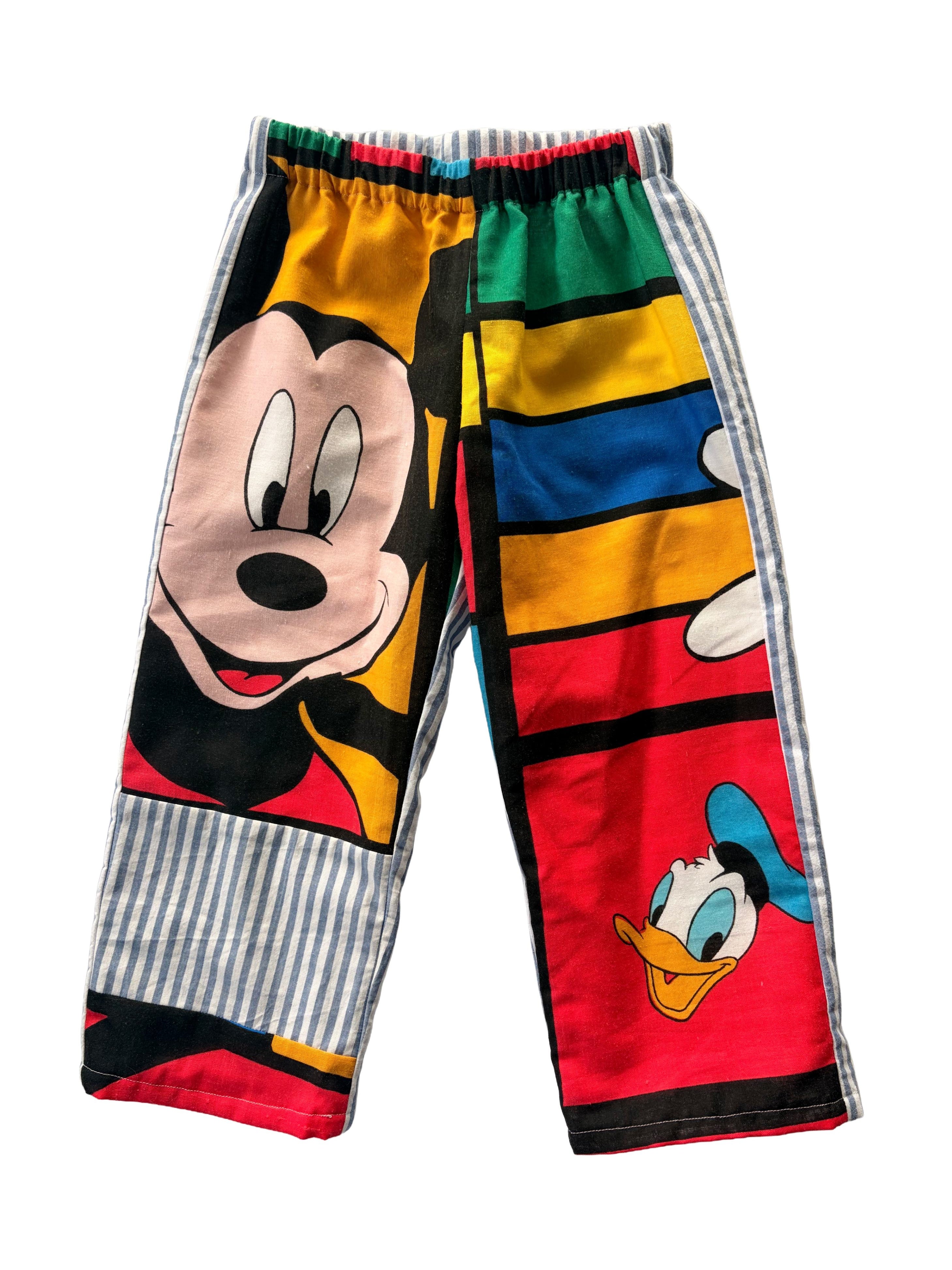 Childrens pants, made from a vintage mickey mouse duvet. Block pattern with blue strips on one leg. Also features donald duck.