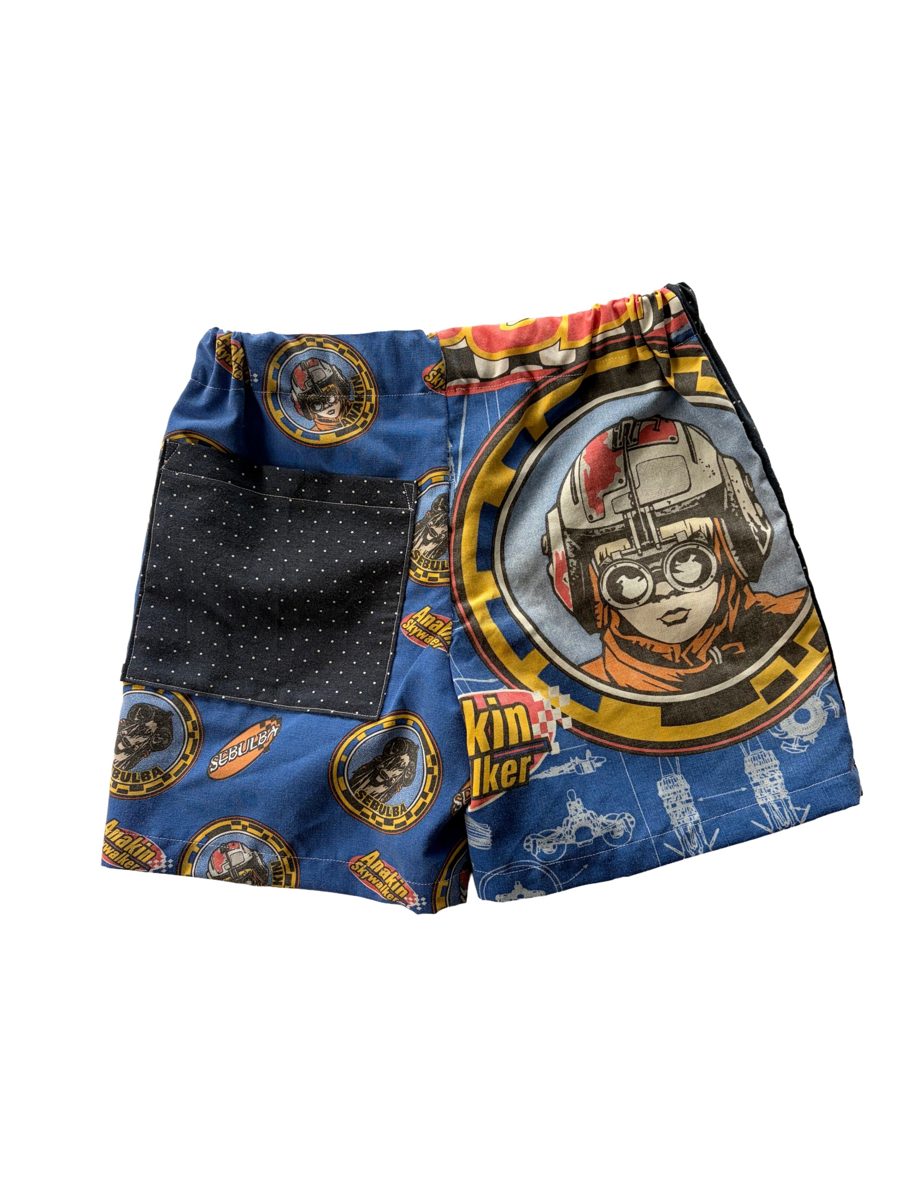 Handmade upcycled kids' shorts with a navy blue polka dot ppocket and a blue Star Wars Anakin panel, made from a secondhand duvet & dress shirt.