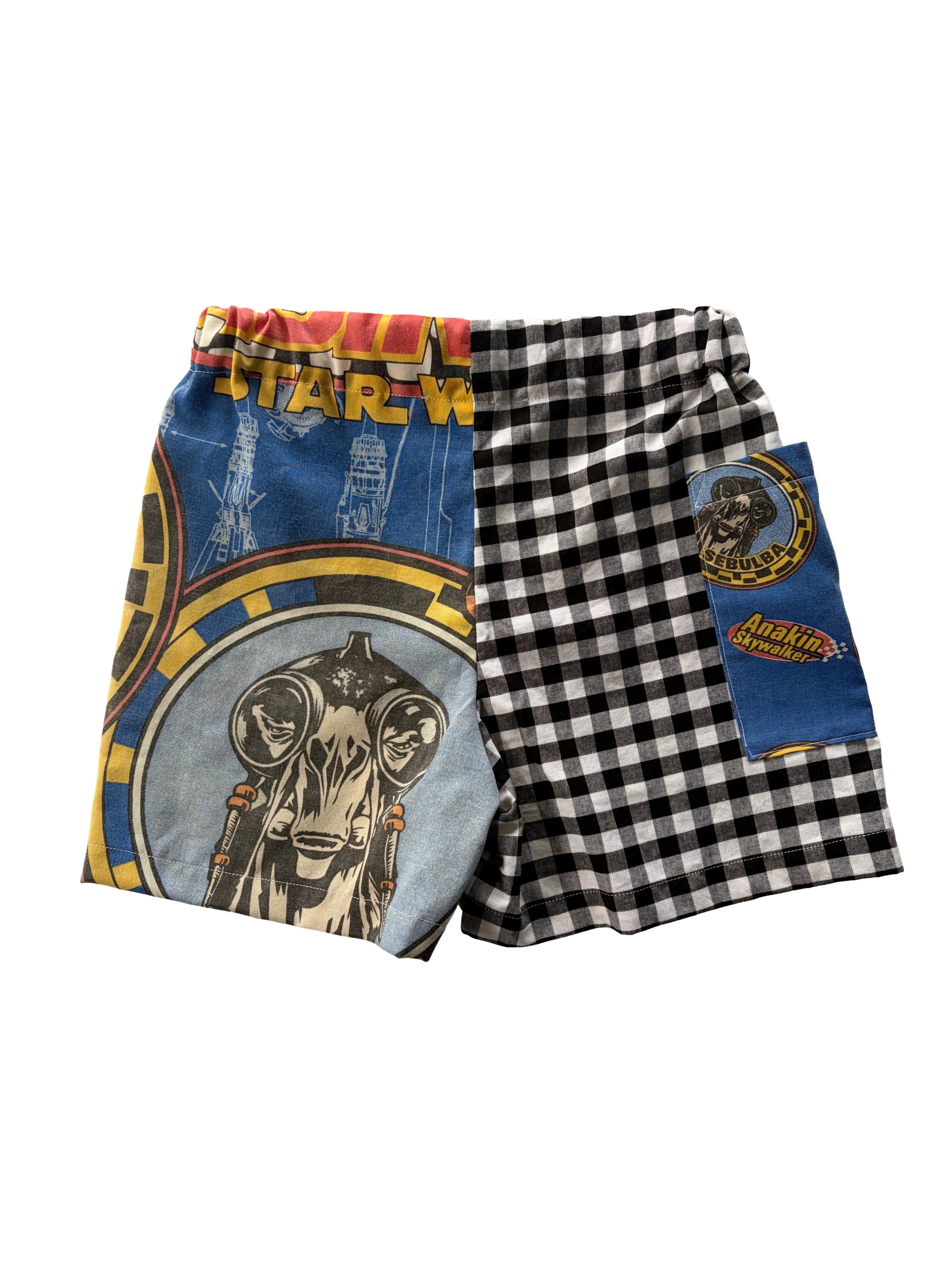 Handmade upcycled kids' shorts with a black and white gingham panel and a blue Star Wars print panel, made from a secondhand duvet & fabric scraps.